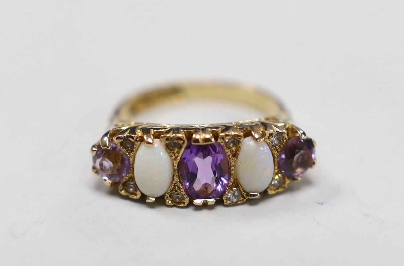 A modern 9ct gold, three stone amethyst and two stone white opal set half hoop ring, with white stone chip spacers, size L/M, gross weight 5 grams.